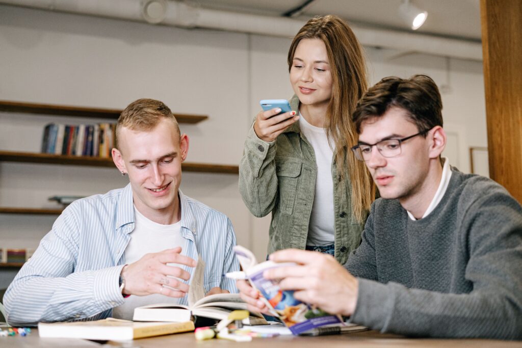 A group of young professionals working together in a modern office setting, showcasing teamwork and creativity.